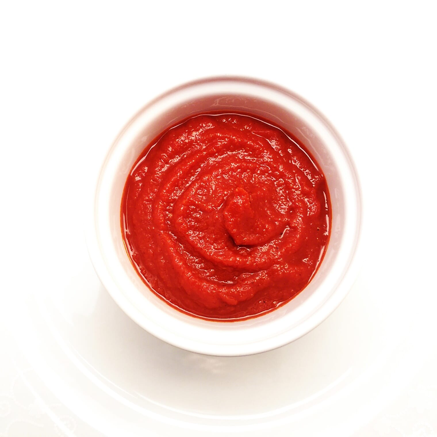 bright red tomato sauce in a white ramekin