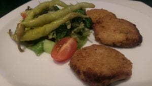 cooked veggie patties with pickled peppers and salad