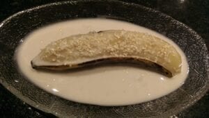 steamed banana with sesame topping in glass bowl