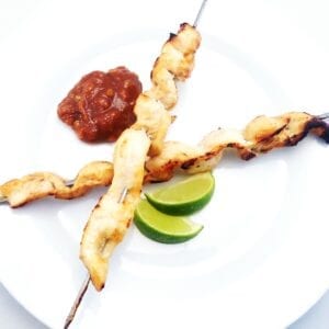 satay chicken skewers, peanut sauce and lime wedge