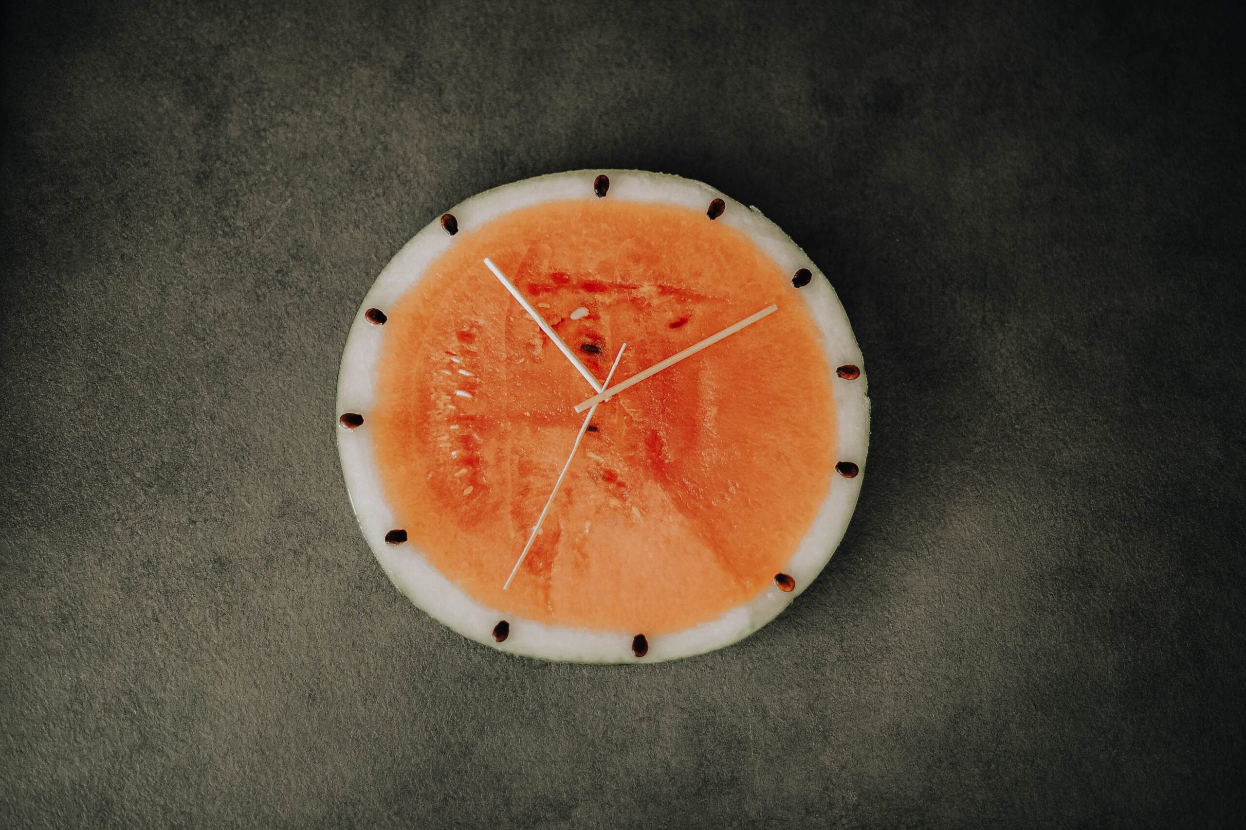 a slice of water melon made to look like a clock