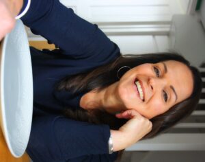 Natasha with an empty grey plate in front of her.